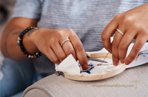 hands of stitcher with embroidery project