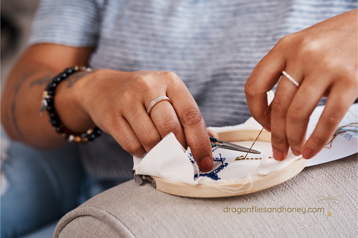 hands of stitcher with embroidery project